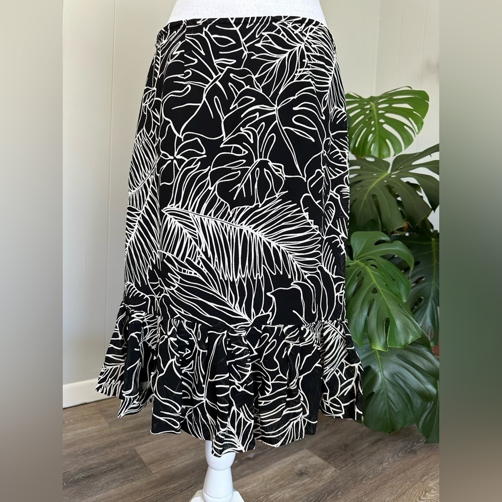 🛍️ Chico’s sheer black with white floral skirt excellent condition.